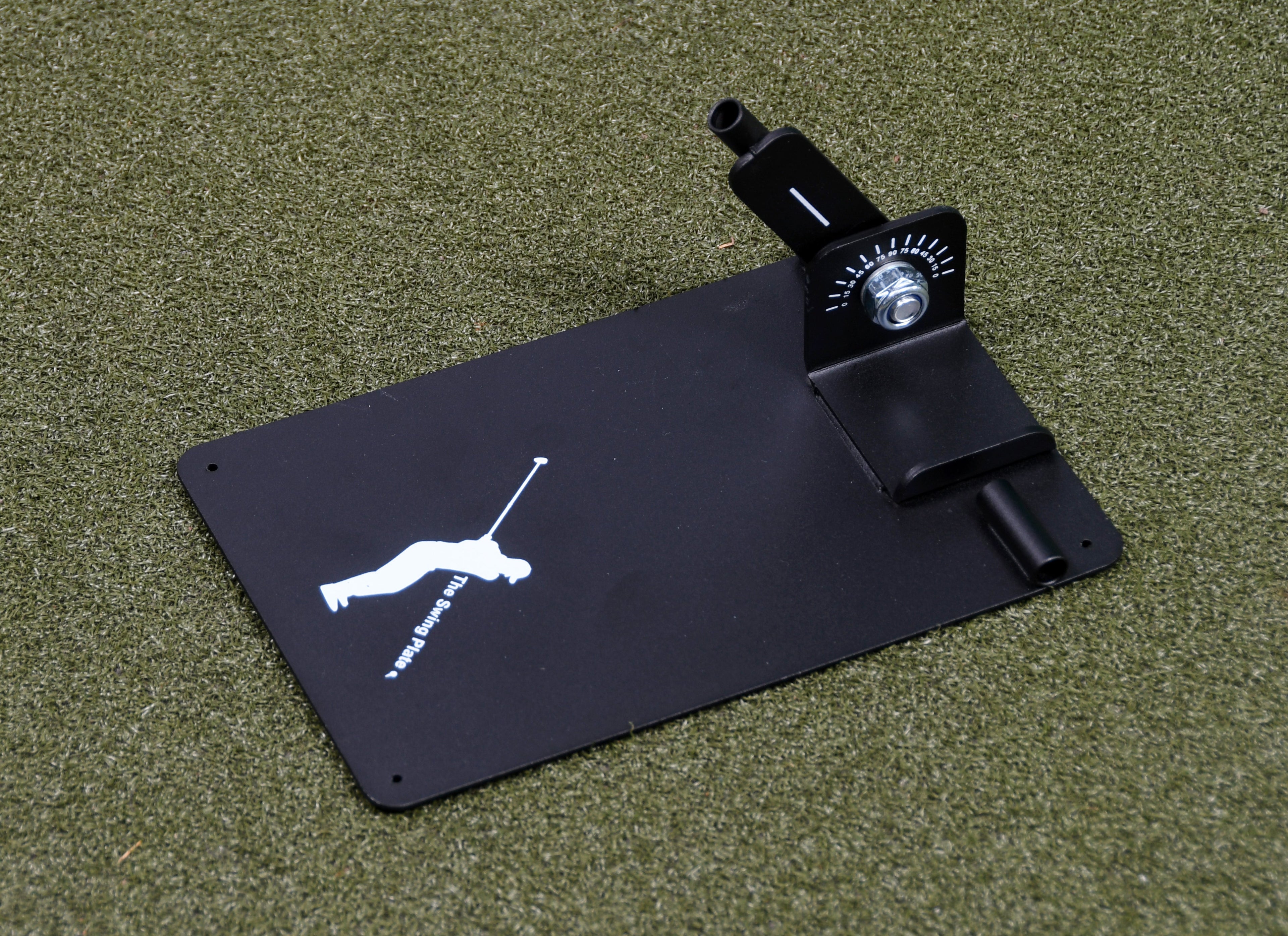 The Swing Plate Base training aid lying flat on a synthetic turf surface