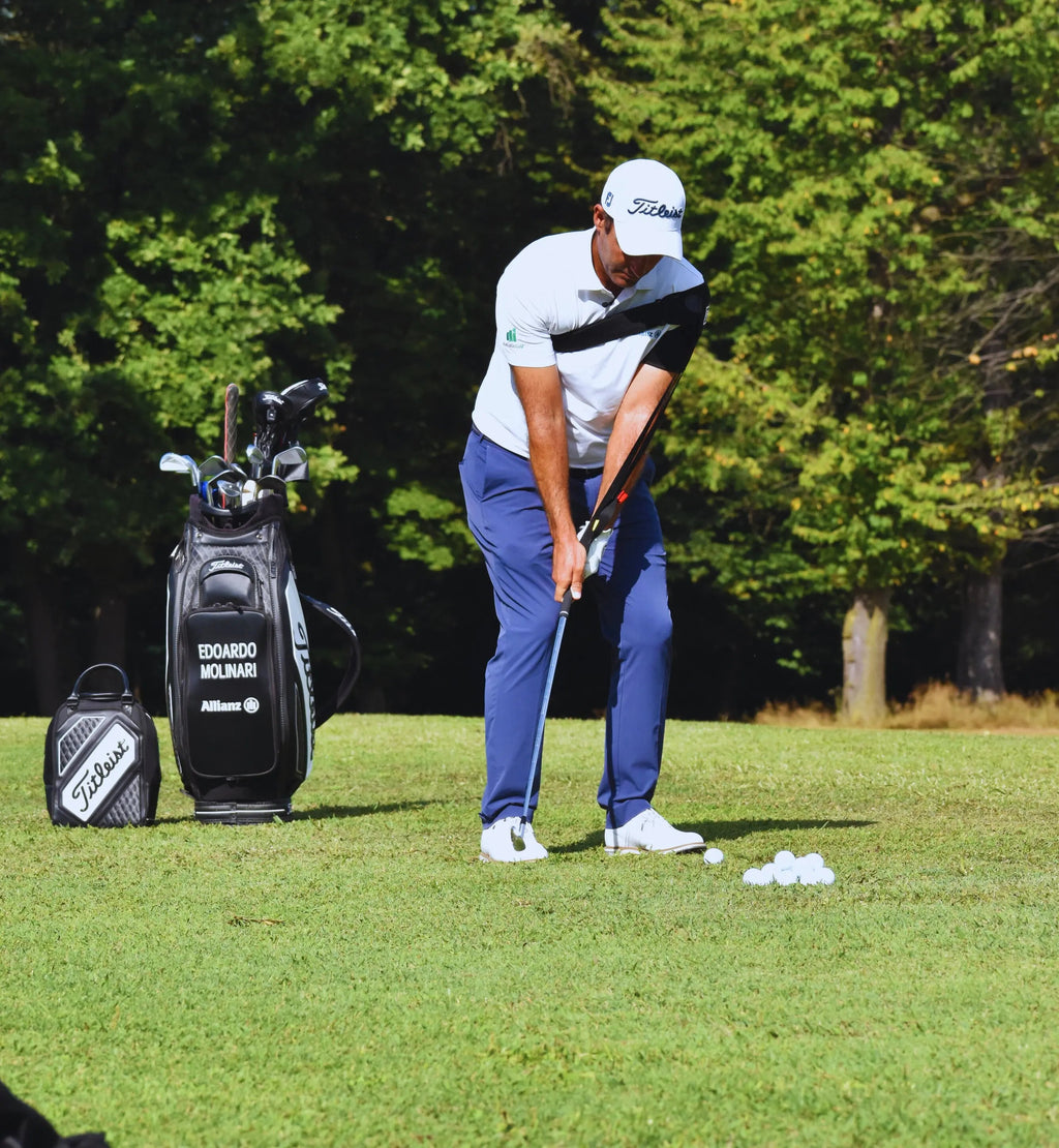 Golfer wearing the Tour-Feel swing trainer practicing full swing mechanics on the range
