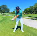 Golfer demonstrating the Sure-Strike swing trainer during a full downswing on the course