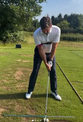 Golfer wearing TRS Slider at address position on practice range