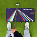 First-person view of a golfer addressing the ball on The Stance Towel alignment aid